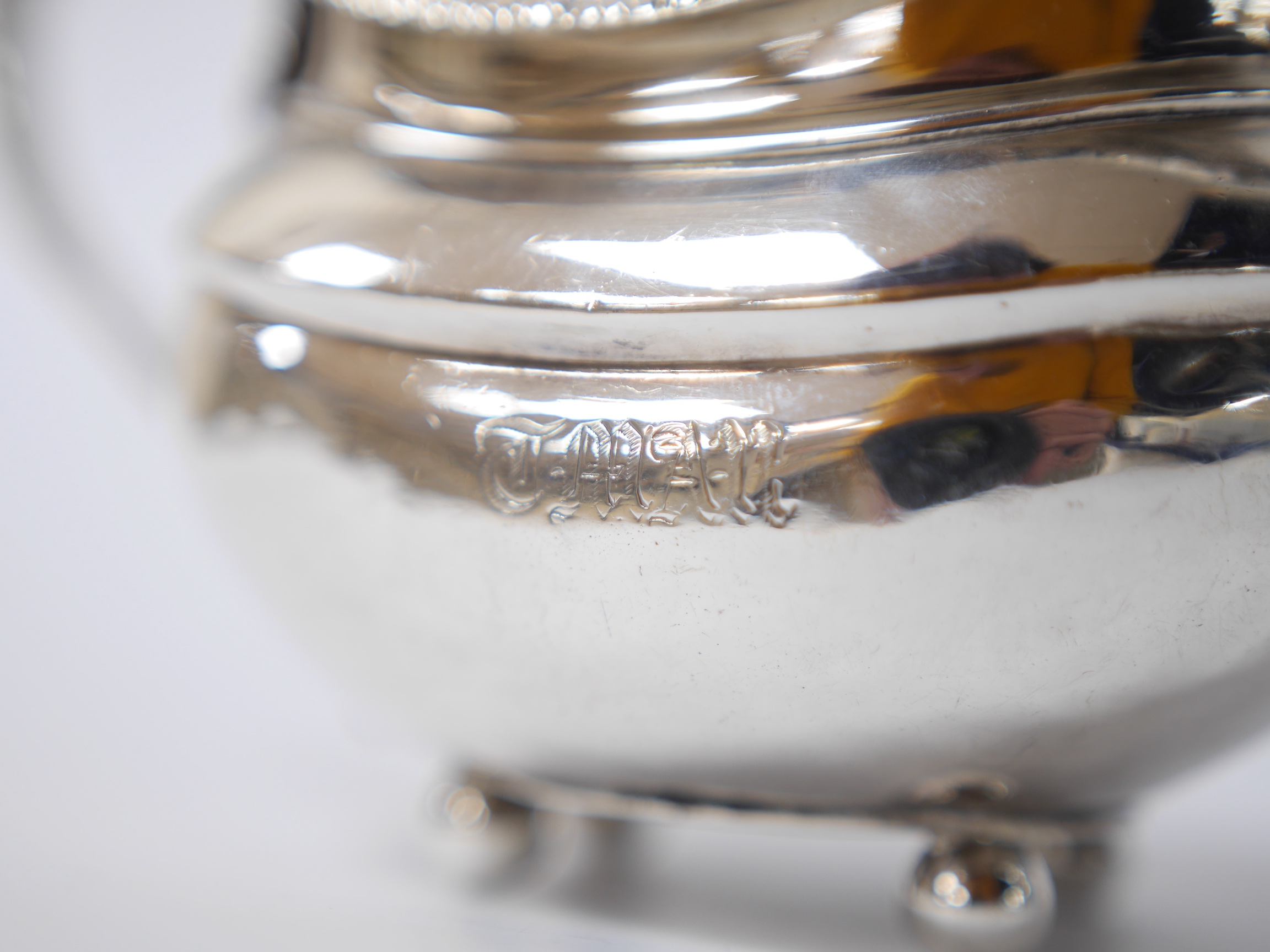 Two George III silver cream jugs, one demi-fluted, with engraved inscription to the base, London, 1807, both with engraved monogram, 11.3oz. Condition - poor to fair